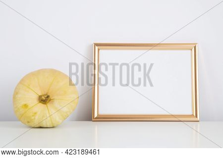 Autumn Frame, Background. Thanksgiving Mockup With Golden Frame And Yellow Pumpkin. Halloween, Fall 
