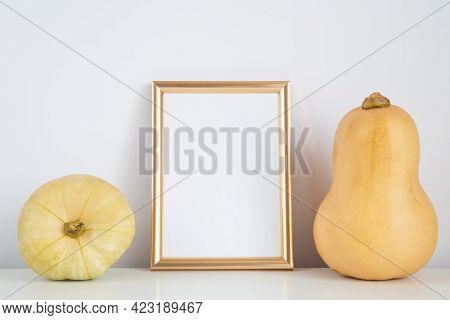 Autumn Frame, Background. Thanksgiving Mockup With Golden Vertical Frame And Yellow Pumpkins. Hallow