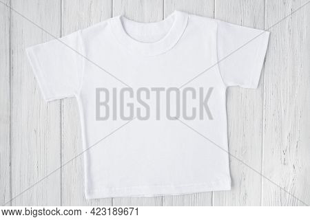 White Tshirt Mockup On Wooden Table Background. Template, Flat Lay. Kid, Child Clothes.