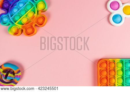 Anti-stress Toys Pop It, Simple Dimple, Snapperz On Pink Background, Copy Space. Concept Trendy Ente