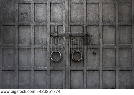 An Old Wrought Metal Gate With Handle, Doorknock, Deadbolt, Can Be Used As A Background