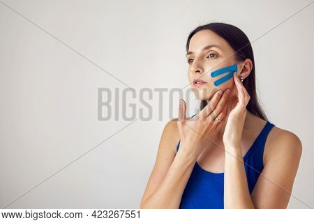 Portrait Of A Young Woman With Pasted Konesiotape For Rejuvenation And Face Tightening