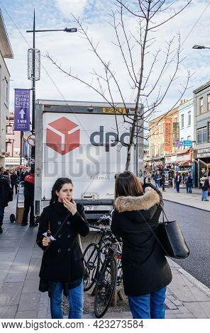 London, United Kingdom - Mar 9, 2017: London Street With Two Young Girls And Dpd Delivery Van In The