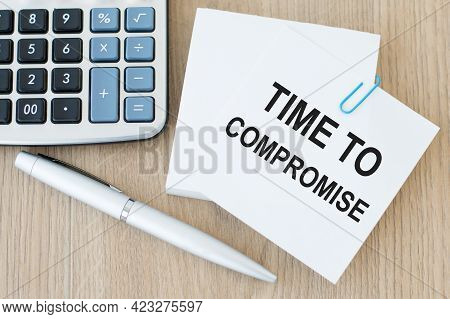 Text Time Compromise Inscription On White Paper For Notes On The Table Next Calculator And Silver Pe