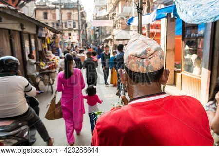 Rikshaw Driver On A Busy Street Wearing Red Shirt.
