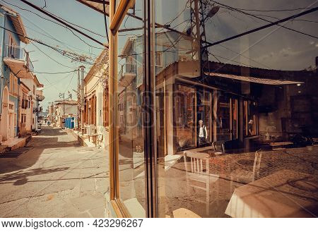 Ayvalik, Turkey: Street Of Small Turkish Town With Cafe And Some Shops In Reflection Of Windows On 2