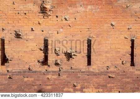 A Loophole In An Old Stone Wall. The Fortification Stone Wall Of An Ancient Castle With Loopholes. B
