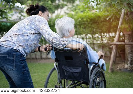Doctor Help And Care Asian Senior Or Elderly Old Lady Woman Patient Sitting On Wheelchair At Park In