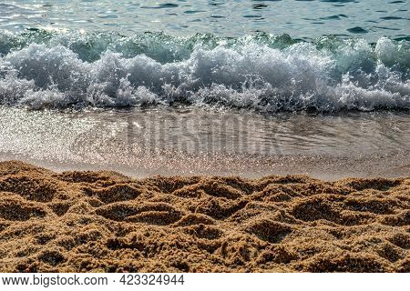 Large-grain Sand Against The Backdrop Of A Sea Wave On The Kleopatra Beach In Alanya (turkey), Close