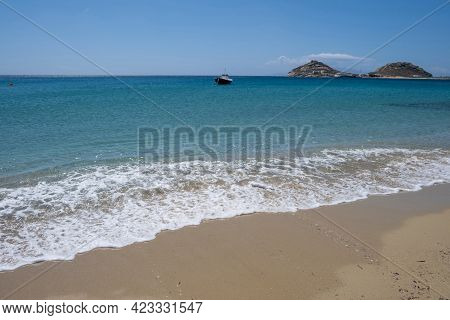 Greece, Cyclades. Traditional Boat Anchored On Blue Color Sea Water