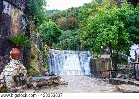 Man-made Waterfall In The City Of New Athos. Attraction In The City Park. The Dam. Water Falls From 