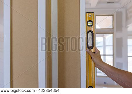 Worker Using Leveling Instrument Check Appropriate Wood Columns Using Level In Under Construction