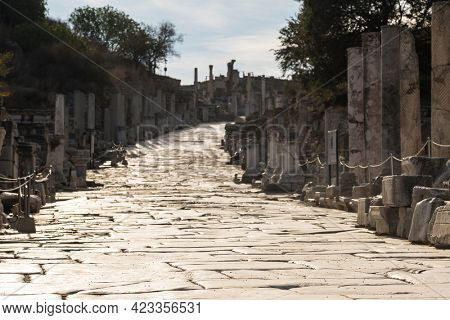 Historic marble slabs of the Curetes street in Ephesus Ancient City at sunny day in Selcuk, Turkey. Ancient and historical road from the roman period. Selective focus