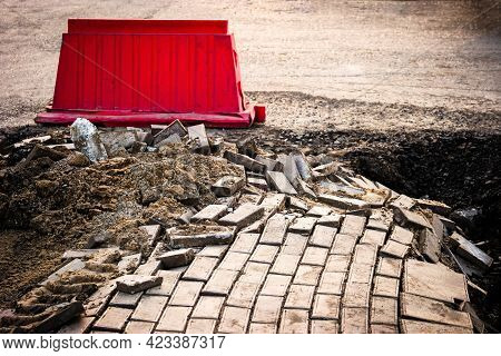 Road Damage Caused By Landslide. Damaged Pavement Fenced By Red Block