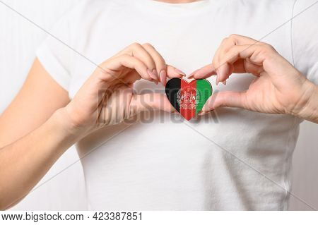 Flag Of Afghanistan In The Shape Of A Heart In The Hands Of A Girl. Love Afghanistan. Respect For Th