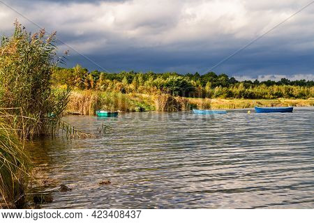 Small Open Colorful Rowboats Moored On Water. Post-mining Reservoir (artificial Lake) Pogoria Iv Bef