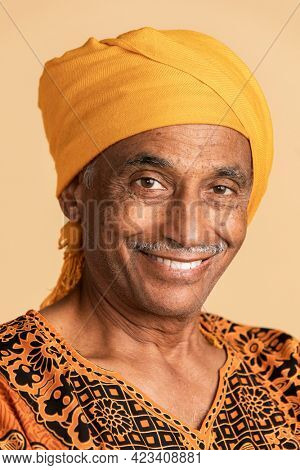 Mixed senior Indian man wearing a yellow turban