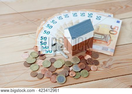 Lot Of Euro Money Near Small Toy House Real Estate Concept, Buying A Home, Rent A House