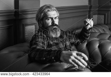 Luxury And Success. Smoke Cigarette While Drink Brandy Or Cognac. Hard Beverage For Real Men. Brutal