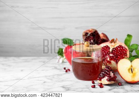 Honey, Pomegranate And Apples On White Marble Table, Space For Text. Rosh Hashana Holiday