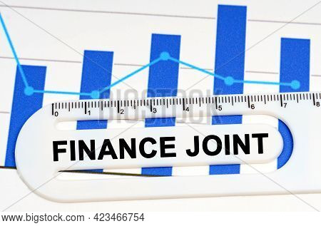 Economy Concept. On The Sheet With Graphs There Is A White Ruler With The Inscription - Finance Join