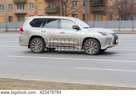 Moscow , Russia - March 2021: Silver Car Lexus Lx 570 Is Driven At Empty City Asphalt Road
