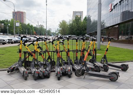 Parking For Electric Scooters In The Square Near The Shopping Center. City Electric Scooter Rental S