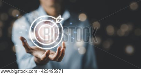 Businessman Hand Holding A Target With A Dart, Point To A Darts Aiming At The Target Center Business
