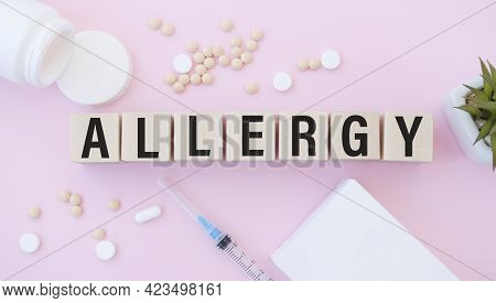 Allergy Text On Wooden Blocks. In Front Of A Row Of Cubes Are Ampoules, In The Background - White Pl
