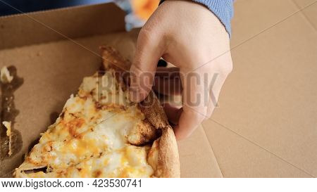 Cheese Pizza In A Cardboard Box Close Up. The Guy Picks Up A Slice Of Delicious Pizza. Close-up.