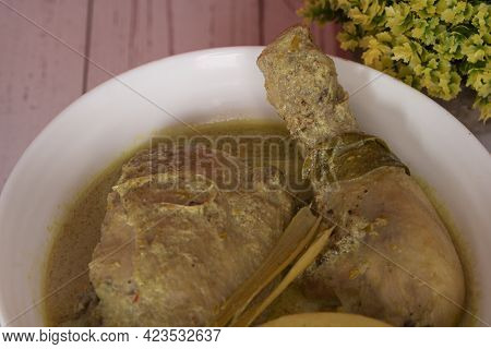 Chicken In Masak Lemak Cili Api In White Bowl. This Is A Popular Local Dish In Malaysia. Selective F