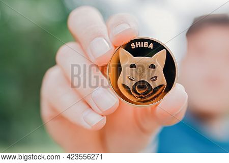 Empuriabrava, Spain, June 2021 - Man Holding Shiba Token On Natural Background, Close Up Shot