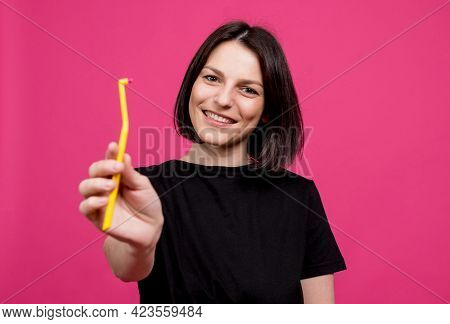 Beautiful Happy Young Woman With Single Tufted Toothbrush On Blank Pink Background