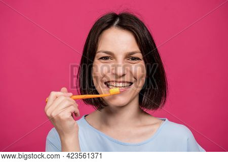 Beautiful Happy Young Woman With Toothbrush On Blank Pink Background