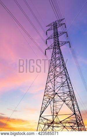 Vertical Silhouette Of Electric Pole With Purple Blue Sky In The Evening