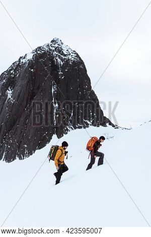Backpackers hiking up Segla mountain, Norway