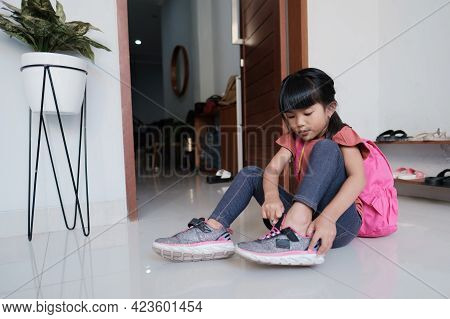 Primary Student Preparing To Go To School In The Morning