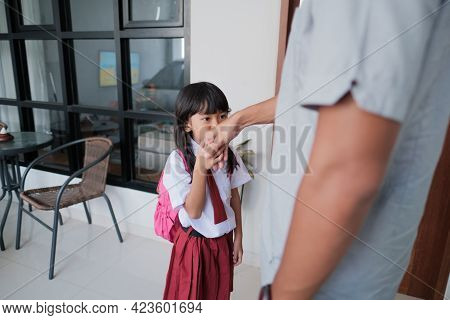 Indonesian Primary School Female Student Shake And Kiss Her Fathers Hand Before Going To School