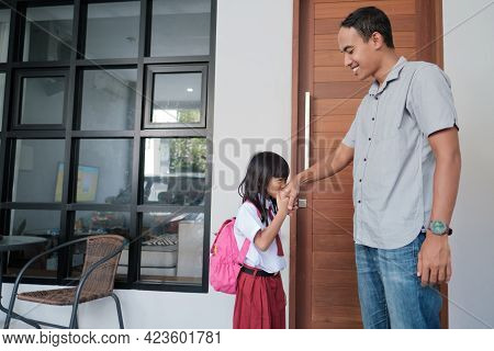 Indonesian Primary School Female Student Shake And Kiss Her Fathers Hand Before Going To School