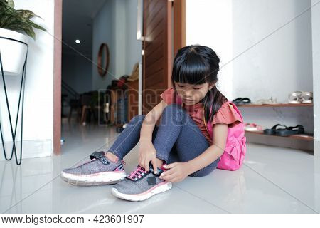 Primary Student Preparing To Go To School In The Morning
