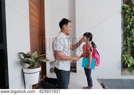 Indonesian Primary School Female Student Shake And Kiss Her Fathers Hand Before Going To School