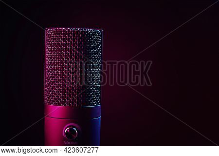 Studio Microphone On Dark Background With Copy Space. Black Professional Condencer Microphone With N