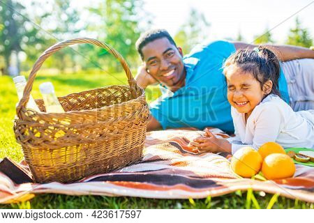 Latin Hispanic Man With Cute Baby Celebrating Fathers Day At Picnic In Sunny Park