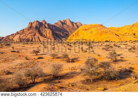 Pontok Mountains Near Spitzkoppe. Red Vivid Granite Rock Formation In Namib Desert At Sunset Time, N