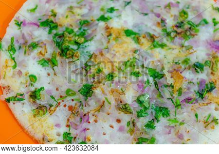 Onion Uttappam Close-up Shot From Top. Coriander Leaves Sprinkled Over