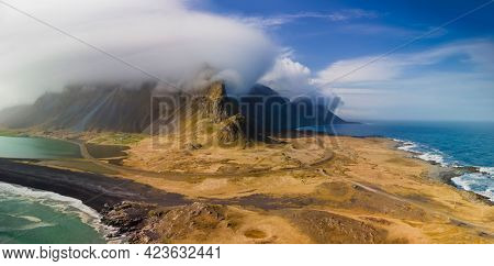 Panoramic view of cloud cover mountains in Iceland eastern shore line