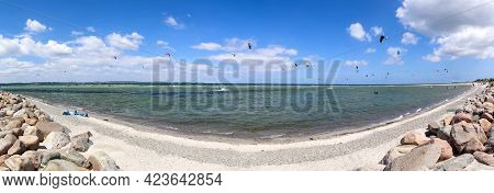 Panorama Of Kite Surfing Activity At The Baltic Sea Beach Of Laboe In Germany On A Sunny Day
