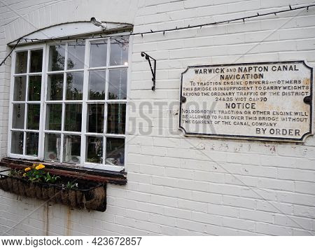 A Vintage Warning Sign Seen On The Wall Of A Canalside Cottage