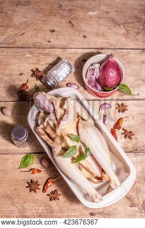 Raw Whole Chicken Carcass For Healthy Food Lifestyle With Traditional Chinese Spices In Ceramic Baki