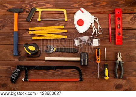 Construction Tools And Equipment On Beautiful Brown Wood Planks Background. Basic Home Repair Hand T